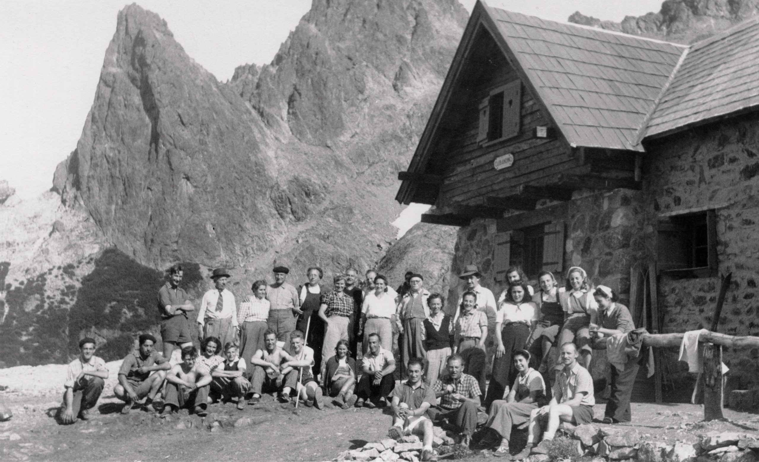 Miembros del Club Andino Bariloche celebran la posesión del Refugio López. Se destaca la presencia de Andrés Lamuniere (el primero de pie, a la izq), a su lado Emilio Frey. Al centro (con boina, anteojos y bigote), Carlos Markstahler. En el medio, sentado con camisa de mangas cortas, Pedro Strukelj (el refugiero), y a su lado, su hija Rosalía, en 1947