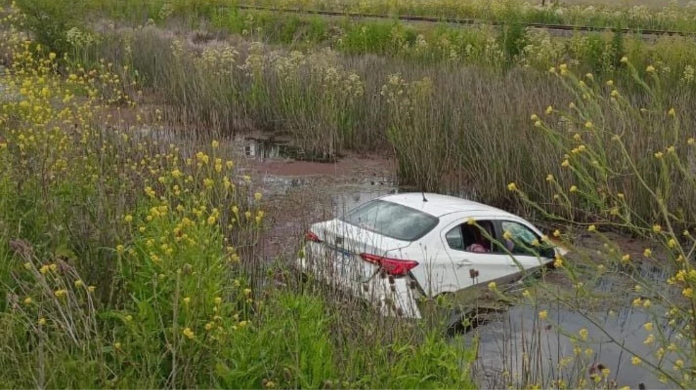 El auto terminó parcialmente hundido en una zanja con agua a la altura del kilómetro 310 de la ruta 2. (Foto: gentileza 0223)