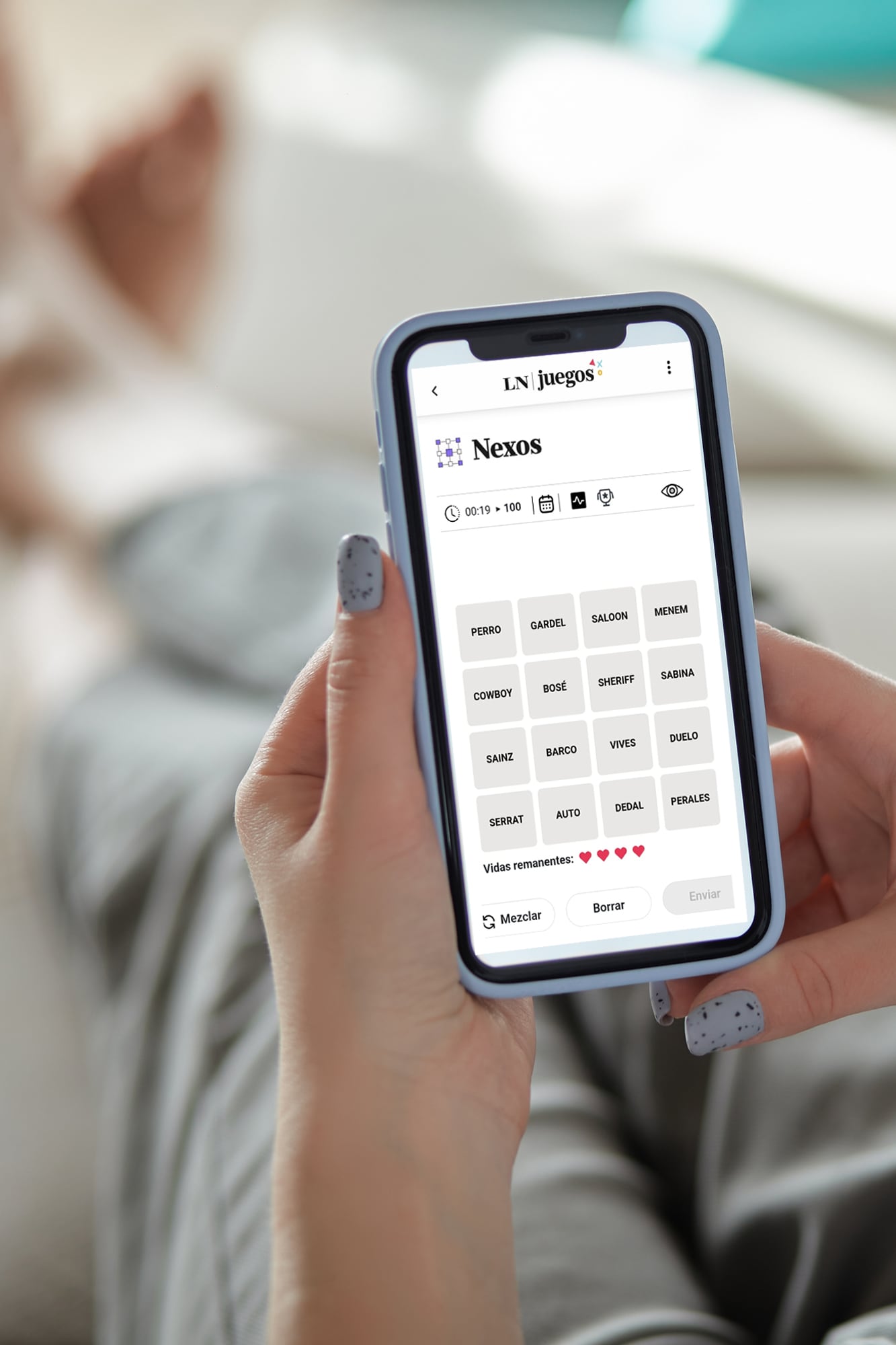 Mock up white screen blank mobile phone in woman hands holding lying on the sofa Back view