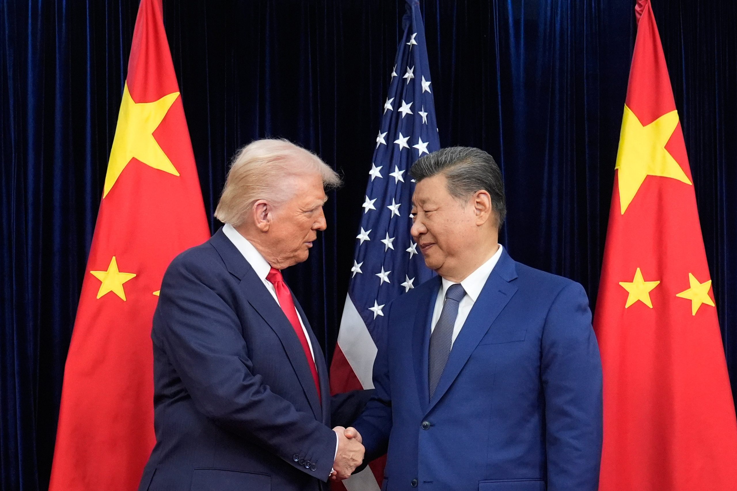 Trump y Xi Jinping se dan la mano antes de su reunión en el Aeropuerto Internacional de Gimhae en Busan, Corea del Sur