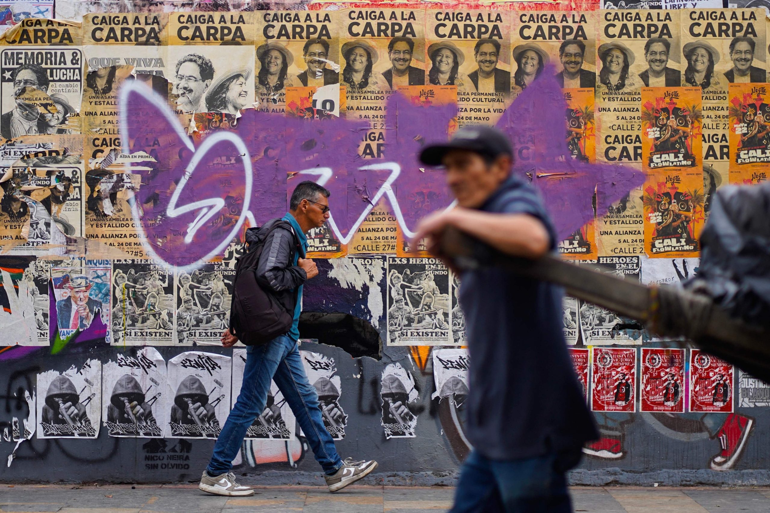 Un hombre pasa frente a propaganda del candidato presidencial de Colombia por la coalición izquierdista Pacto Histórico, Iván Cepeda, en Bogotá