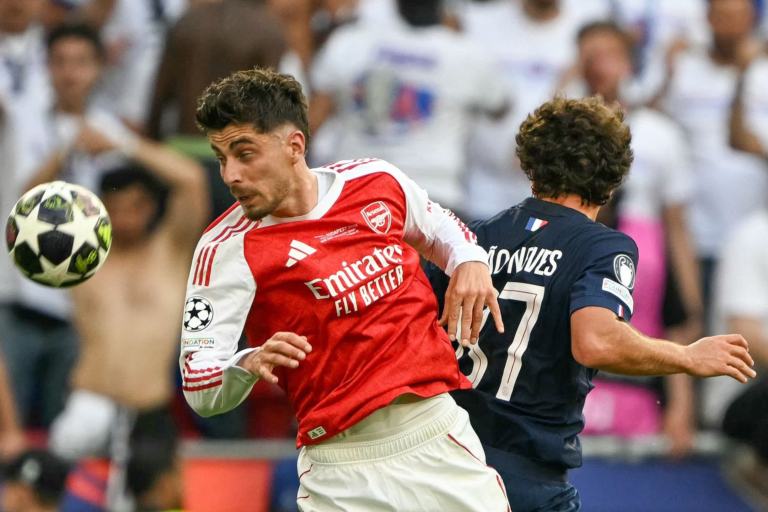Kai Havertz disputa la pelota con João Neves