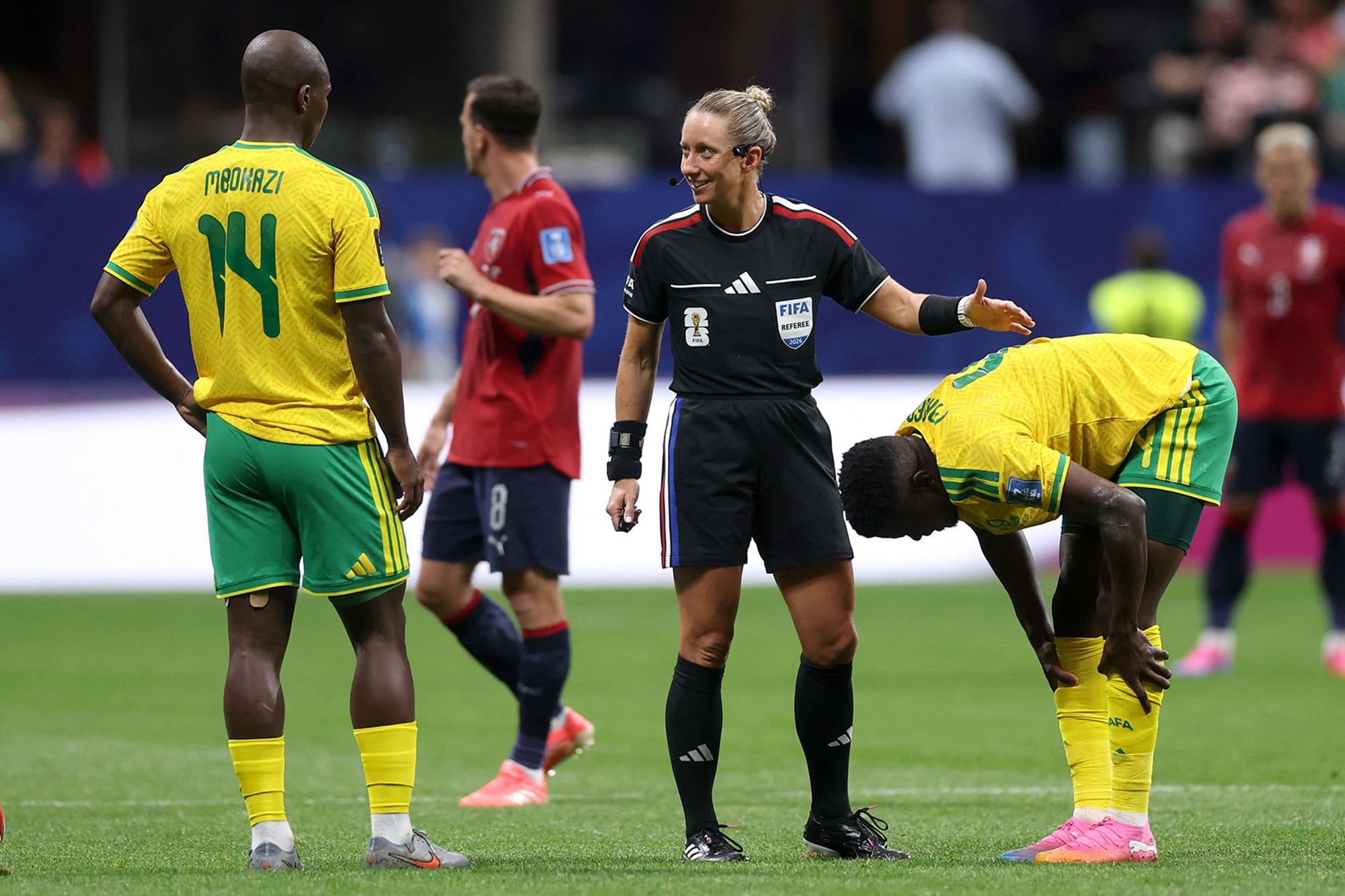 Tori Penso, la árbitra estadounidense, charlando con Mbekezeli Mbokazi, de Sudáfrica en el partido ante República Checa