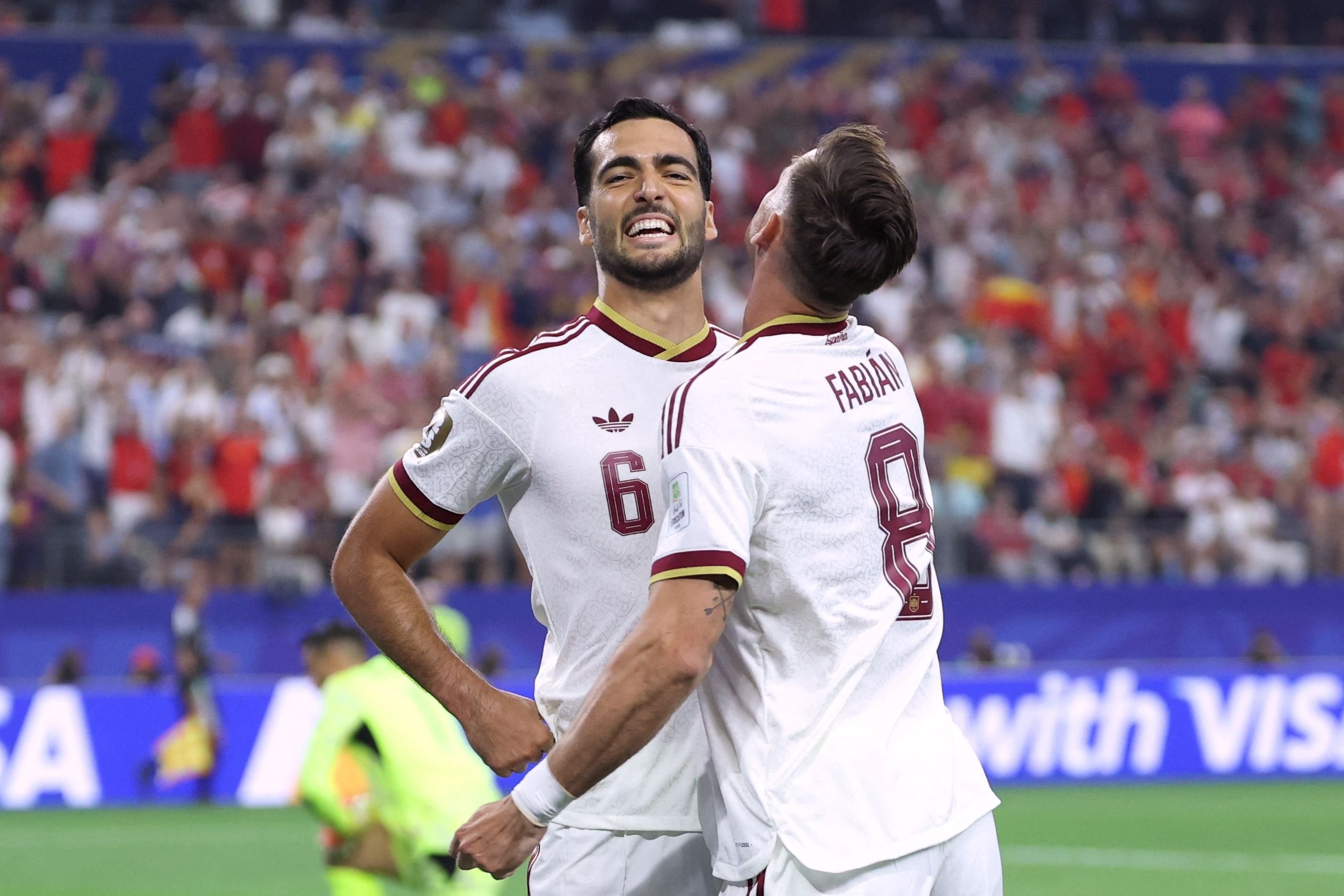 Spain's midfielder #06 Mikel Merino celebrates scoring his team's first goal with teammate midfielder #08 Fabian Ruiz during the 2026 World Cup round of 16 football match between Portugal and Spain at the Dallas Stadium in Arlington on July 6, 2026. (Photo by Thomas COEX / AFP)