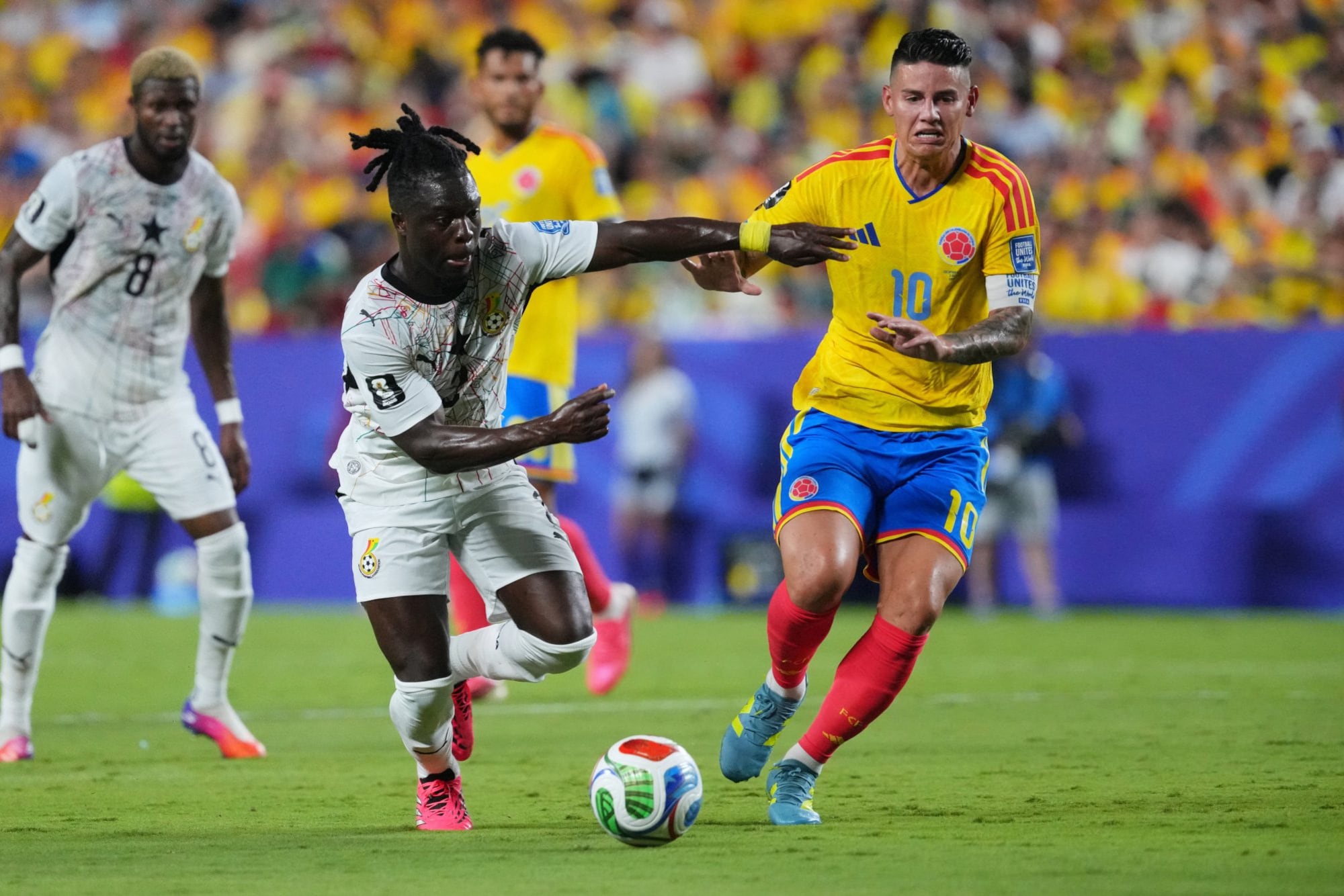 Ghana's Alidu Seidu (2) and Colombia's James Rodriguez battle for the ball during the World Cup round of 32 soccer match in Kansas City, Mo., Friday, July 3, 2026. (AP Photo/Ed Zurga)
