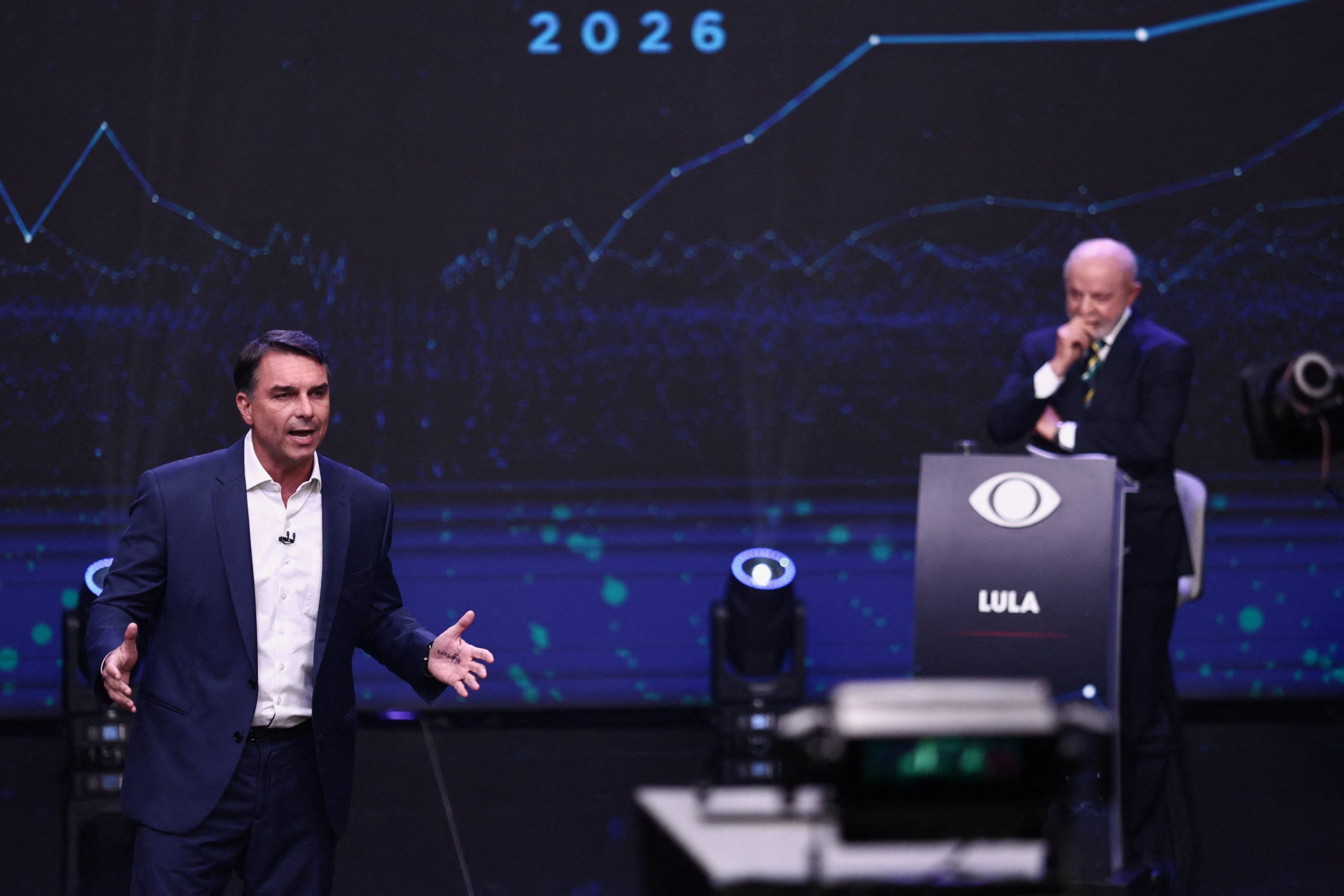Brazilian presidential candidate Flavio Bolsonaro speaks as Brazilian presidential candidate Luiz Inacio Lula da Silva listens during a presidential debate, ahead of the runoff presidential election, in Sao Paulo, Brazil, October 18, 2026. REUTERS/Jean Carniel