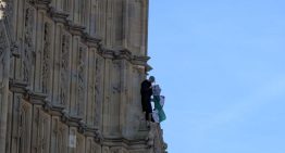 Un hombre se encarama a la torre del Big Ben enarbolando la bandera palestina