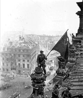 Imagen secundaria 2 - En la primera imagen, el general alemán Hans-Jürgen Stumpff firma el acta definitiva de rendición alemana el 8 de mayo de 1945. En la segunda, generales dialogan sobre la rendición. Soldados soviéticos izan la bandera roja sobre el Reichstag en Berlín, en la tercera foto.