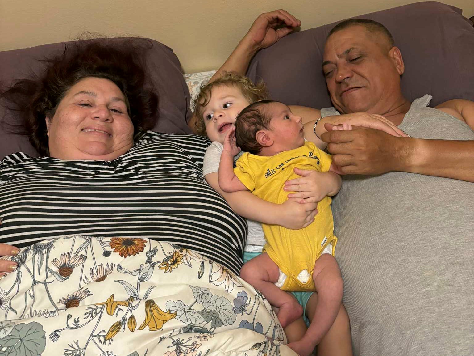 Los hijos de Yelenis Pérez, cargados por sus padres.