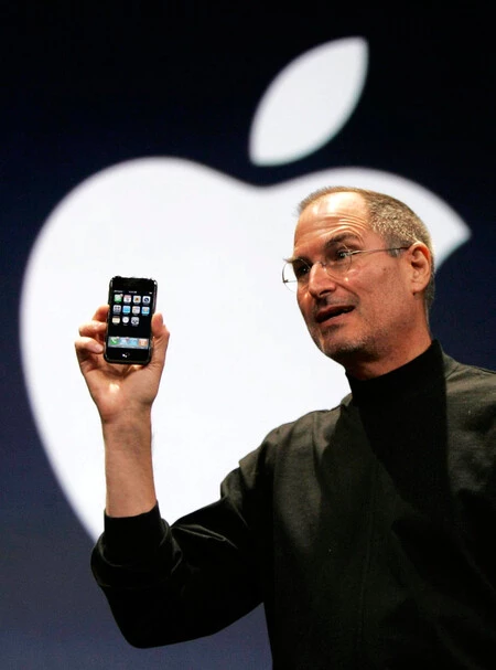 The Then Apple Ceo Steve Jobs Holds Up The First Iphone