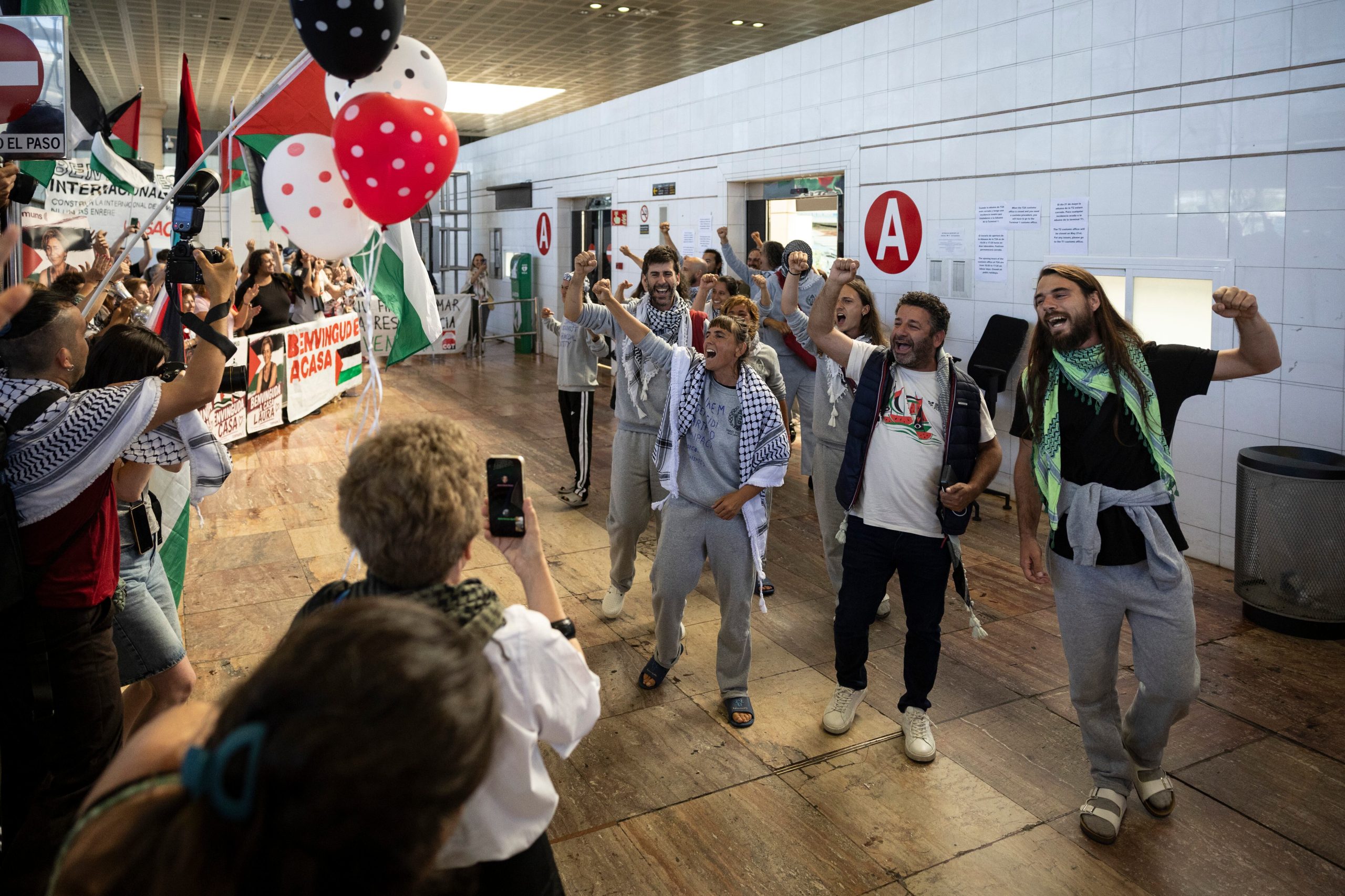 Participantes en la Global Sumud Flotilla en la zona de llegadas del aeropuerto de Barcelona tras ser deportados de Israel.