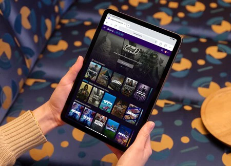 Mockuuups Female Holding Ipad Mockup In Colorful Lounge Setting